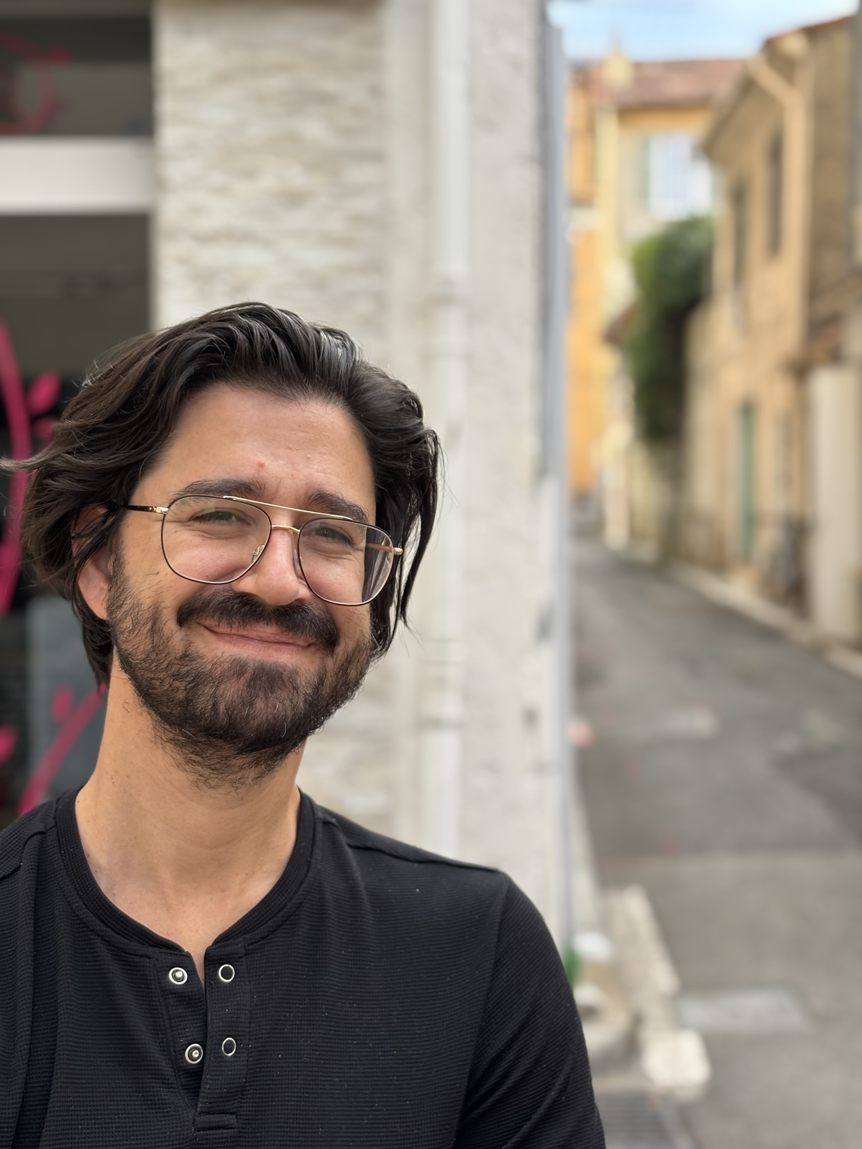 Jason Nellis, smiling on a street in the south of France