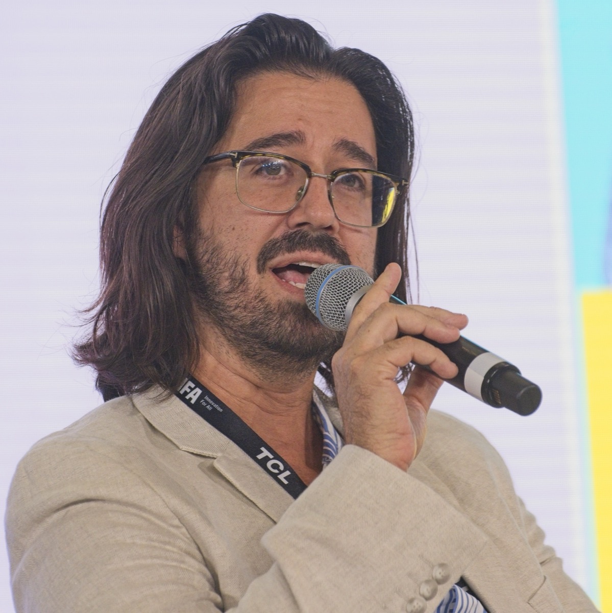 Jason Nellis speaking on a panel at IFA 2026 in Berlin, microphone in hand