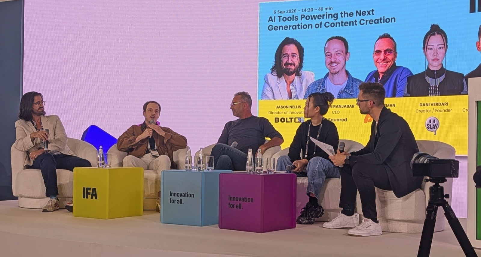 Jason Nellis on stage at IFA 2026 in Berlin for the panel "AI Tools Powering the Next Generation of Content Creation", with the speaker line-up on the screen behind him